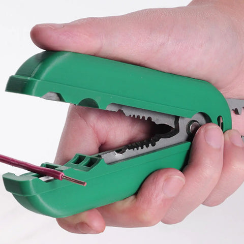 Hand holding a green Compact Palm Sized Multifunctional Cable Stripper For Networking Cables with wire inserted, ergonomic design.