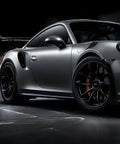 Pro Grade Black Wheel Rim Protectors Four Pack Universal Tire Edge Guards on black alloy rims of a sleek sports car.