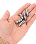 Hand holding Five Sixteenth Inch Dowel Pins, One Inch Length, Heat Treated Alloy Steel For Extra Hardness, Bright Finish, Precise Alignment, Rust Resistant, Built To Last, Tough As Nails, 20 Pieces.