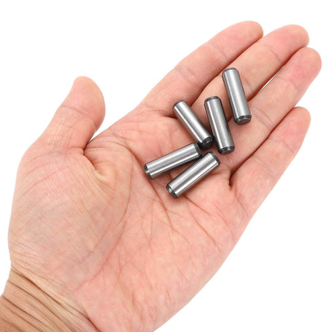 Hand holding Five Sixteenth Inch Dowel Pins, One Inch Length, Heat Treated Alloy Steel For Extra Hardness, Bright Finish, Precise Alignment, Rust Resistant, Built To Last, Tough As Nails, 20 Pieces.