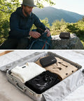 Grab And Go First Aid Kit Ultra Portable Compact Waterproof Emergency Supplies on rock and in suitcase, outdoor use.