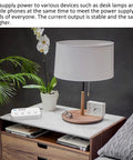 Heavy Duty Smart Surge Protector Power Strip With Four Usb Ports For Fast Phone Charging And Ultra Tidy Home Office Outlet Organization Heavy Hitter Setup on a marble tabletop next to a lamp and plant.