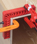 Heavy Duty Positioning Squares For Woodworking Set Of Eight Precision Layout Gauges With Dual Scale Edges clamped on wood.