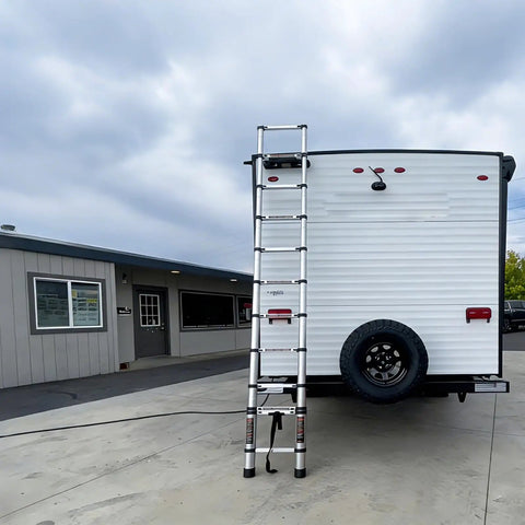12.5 Foot Portable Aluminum Telescoping RV Ladder Heavy Duty, Rust Resistant, Fits Lippert On The Go Receiver, Easy Folding Design For Rooftop Access And Camp Life. Extended beside an RV.