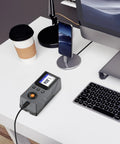 Pro Grade Surface Roughness Tester With 5 Micron Diamond Stylus Inductive Sensor on a white desk next to a computer and phone.