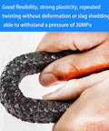 Graphite braided compression packing, 1/8 in x 1/8 in, 10 ft, black braid held between fingers.