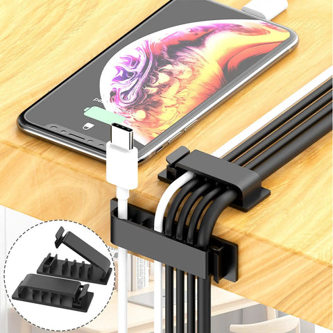 Close-up of cable clips from 327 Piece Cable Management Kit With Cord Protectors, Cable Clips, Cord Holders on wooden desk