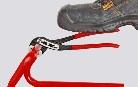 10 Inch Alligator Pliers With 9 Adjustment Positions Delivering 30 Percent More Grip, shown gripping a red metal pipe.