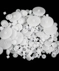 Assorted gears from the 200 Piece Plastic Gear Set Kit For DIYers Working On Models And Toys on black background.