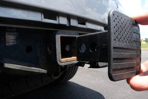 Patriotic 2 Inch Tow Hitch Cover Plug With American Flag Design being installed on truck, universal fit for 2 inch hitch receivers
