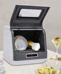 Hassle-Free Countertop Dishwasher With A Slick Stainless Steel Interior, Portable kitchen workhorse showcasing clean dishes inside.