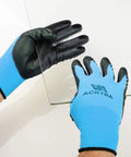 Person wearing Ultra Thin PU Safety Work Gloves 12 Pairs Black Large Model WG002 handles glass sheet.