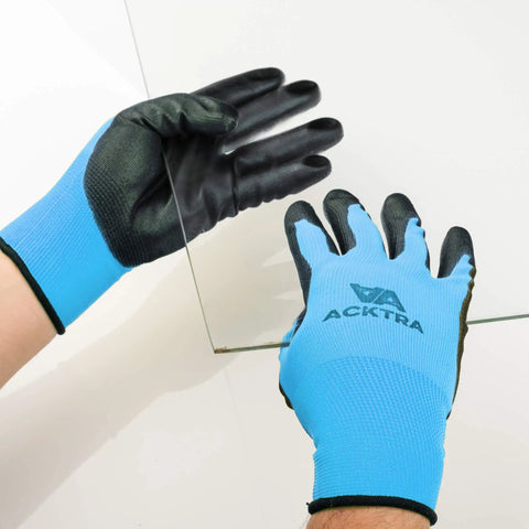 Person wearing Ultra Thin PU Safety Work Gloves 12 Pairs Black Large Model WG002 handles glass sheet.