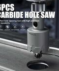 Carbide hole saw set (6-piece) with titanium-plated pilots and springs, mounted on a drill.