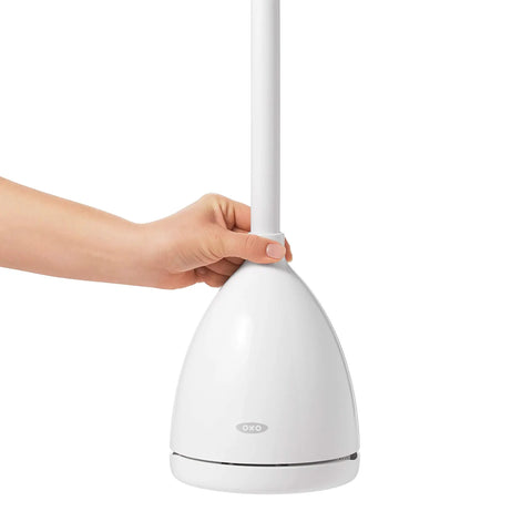 Concealed Toilet Plunger With Auto Open Canister Ventilated Drip Tray Flat Top Handle in white, being held securely.