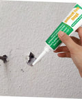Wall Repair Paste Set With Self Adhesive Mending Cream, Scraper And Spout For Quick Crack Fix being applied to wall hole