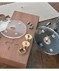 Built Tough And Ready To Roll Top Shelf Metric Router Guide Bushing Set With Brass Template Bits Lock Nut Adapter and Secure Case, showing brass bushings and router plate.