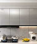Modern kitchen with stainless steel look peel and stick contact paper silver vinyl wrap on cabinets, cooktop visible