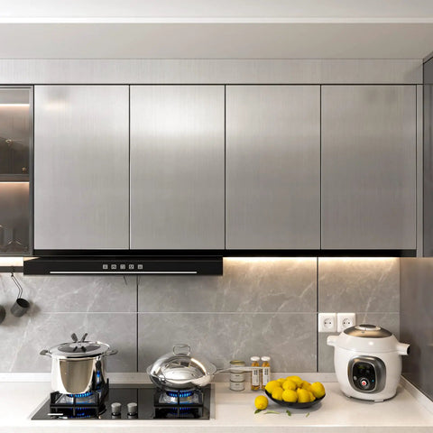 Modern kitchen with stainless steel look peel and stick contact paper silver vinyl wrap on cabinets, cooktop visible