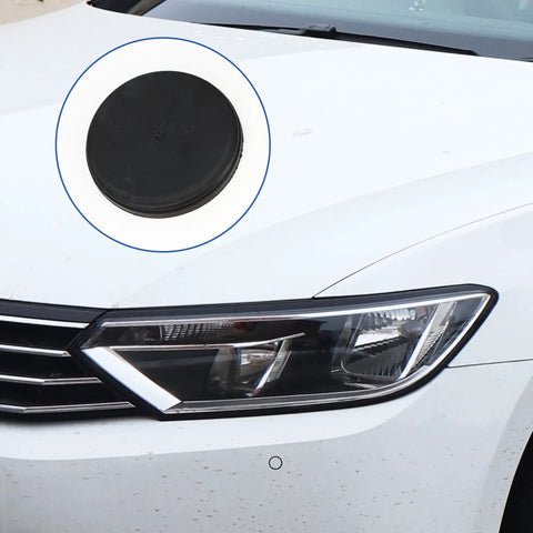 Close-up of black Direct Fit VW CC HID Xenon Headlight Dust Cap Dust Cover Bulb Plug Replacement on white car hood.