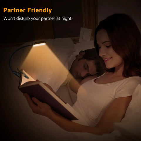 Woman reading in bed with rechargeable clip on reading light with 16 LED, 3 color temperatures and stepless dimming for eye care
