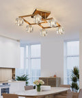 Modern geometric chandelier with crystal orb globes in a bright dining room setting.