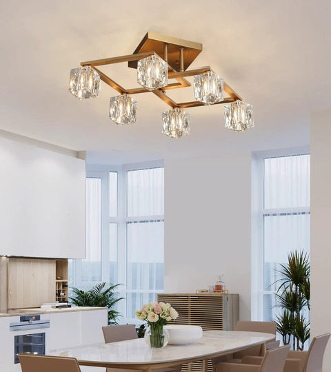 Modern geometric chandelier with crystal orb globes in a bright dining room setting.