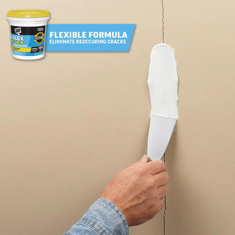 Hand using putty knife with Alex Flex Flexible Spackling White 16 Oz Won’t Sink Shrink Or Crack Sandable And Paintable Formula on wall
