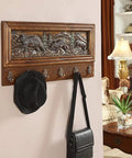 Rock Solid Wall Mounted Coat Rack Featuring Creative Embossed Design And Sturdy Zinc Alloy Hooks with a black hat and bag.