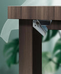 Close-up of Heavy Duty Folding Hinge Bracket Pair With Self Locking Design attached to a wooden table leg for secure support.