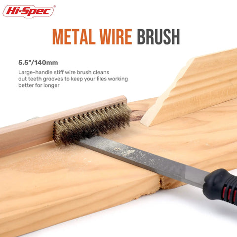Metal wire brush cleaning grooves on a wooden board, close-up view of brush and handle for file maintenance.
