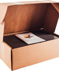 Open cardboard box displaying Top Shelf Car Sound Deadener 150 Mil Thick Self Adhesive Closed Cell PE Foam liner and installation guide.