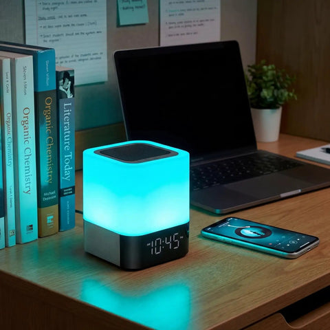 Five In One Night Light Bluetooth Speaker Alarm Clock MP3 Player With Touch Sensor LED Lamp on desk near laptop