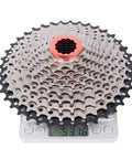 Eight To Twelve Speed Road And Gravel Bike Cassette Freewheel, 11-25 To 50T Range, shown on scale indicating weight