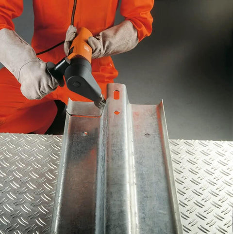 5.0 50H230V Nibbler For Sheet Metal Cutting And Shaping Heavy Duty Electric Tool used on metal sheet by worker in orange suit