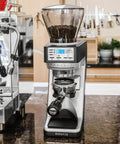 Straight Fire Conical Burr Coffee Grinder Featuring Precision Grind By Weight Tech, sleek design with beans in hopper.