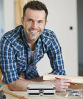 Rugged As Nails Portable Aluminum Tool Box With Secure Locking Lid And Impact Resistant Carry Case on wood table with smiling man.
