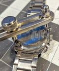 Adjustable Watch Back Remover Tool with Wrench Style Case Opener in use on metal watch for battery replacement