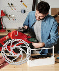 Complete Front And Rear Mechanical Disc Brake Kit With Heavy Duty Rotors And Precision Calipers Plus All Mounting Bolts For Mountain Bikes displayed during installation.