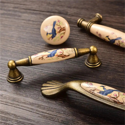 4 Pack Ceramic Cabinet Knob Pulls Set with bird design, durable rust-resistant metal handles on wooden surface