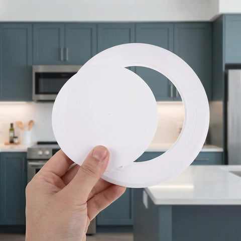 Hand holding No Fuss Peel And Stick White Round Plumbing Access Panel With Super Secure Grip Removable Abs Pipe Hole Cover For Ceiling And Drywall Six Inch No Drill Quick Swap.