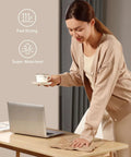 Fantasticlean tan microfiber cleaning cloth being used to wipe a desk beside a laptop (front view).