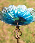 Close-up of blue glass bird bath and feeder with metal stake, four pronged stable base for yard and garden, 31 inch outdoor height.