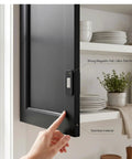 Magnetic Cabinet Door Catch Kit With Adhesive Mount 20 Stainless Steel Drawer Latches securing a black cabinet door in a kitchen setting