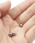 Carbon Steel Bearing Balls 6mm Set Of 100, Precision Ground And Smooth Finish For Machinery, Durable Bearing Components That Reduce Maintenance And Deliver Reliable Performance, shown in hand