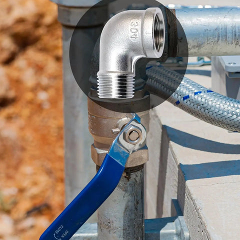 2 Pack Stainless Steel 304 90 Degree Elbow Fittings, 3/4 NPT Threaded, showing installed in plumbing system outdoors