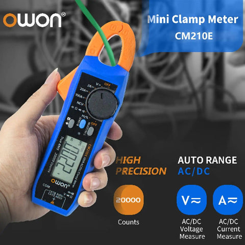 Hand holding Compact Digital Clamp Meter 100A True RMS Multimeter, measuring AC/DC current and voltage, blue and orange design.