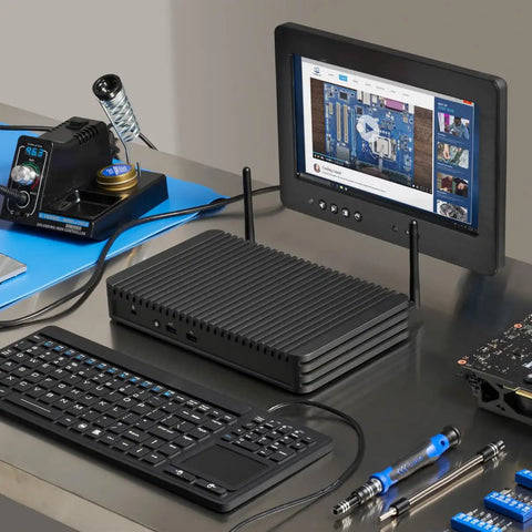 Rugged Fanless Mini Pc Built Tough For The Grind, Featuring Core I5 Processor, 8Gb Ram, 1Tb Ssd, Dual Lan, 12V To 24V Power, Perfect For Industrial Kiosks And Digital Signage Setup, with keyboard and monitor on a workspace.