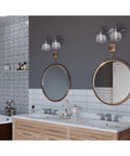 Two Light Coastal Bath Vanity Fixture With Clear Double Prismatic Glass Shades In Antique Nickel Archie Collection in bathroom setting.