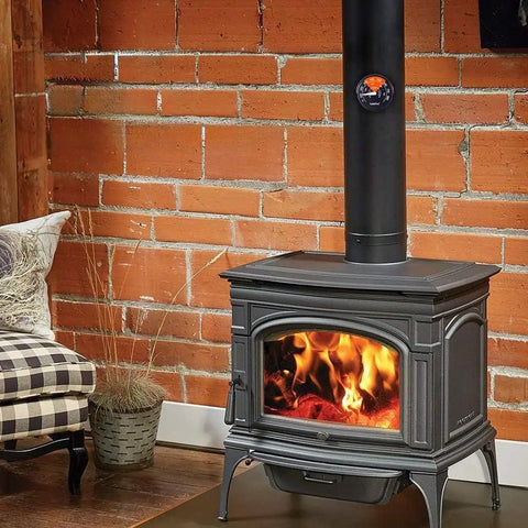 Magnetic Wood Stove Thermometer With White Needle on black stove pipe, clear display in rustic living room with brick wall.